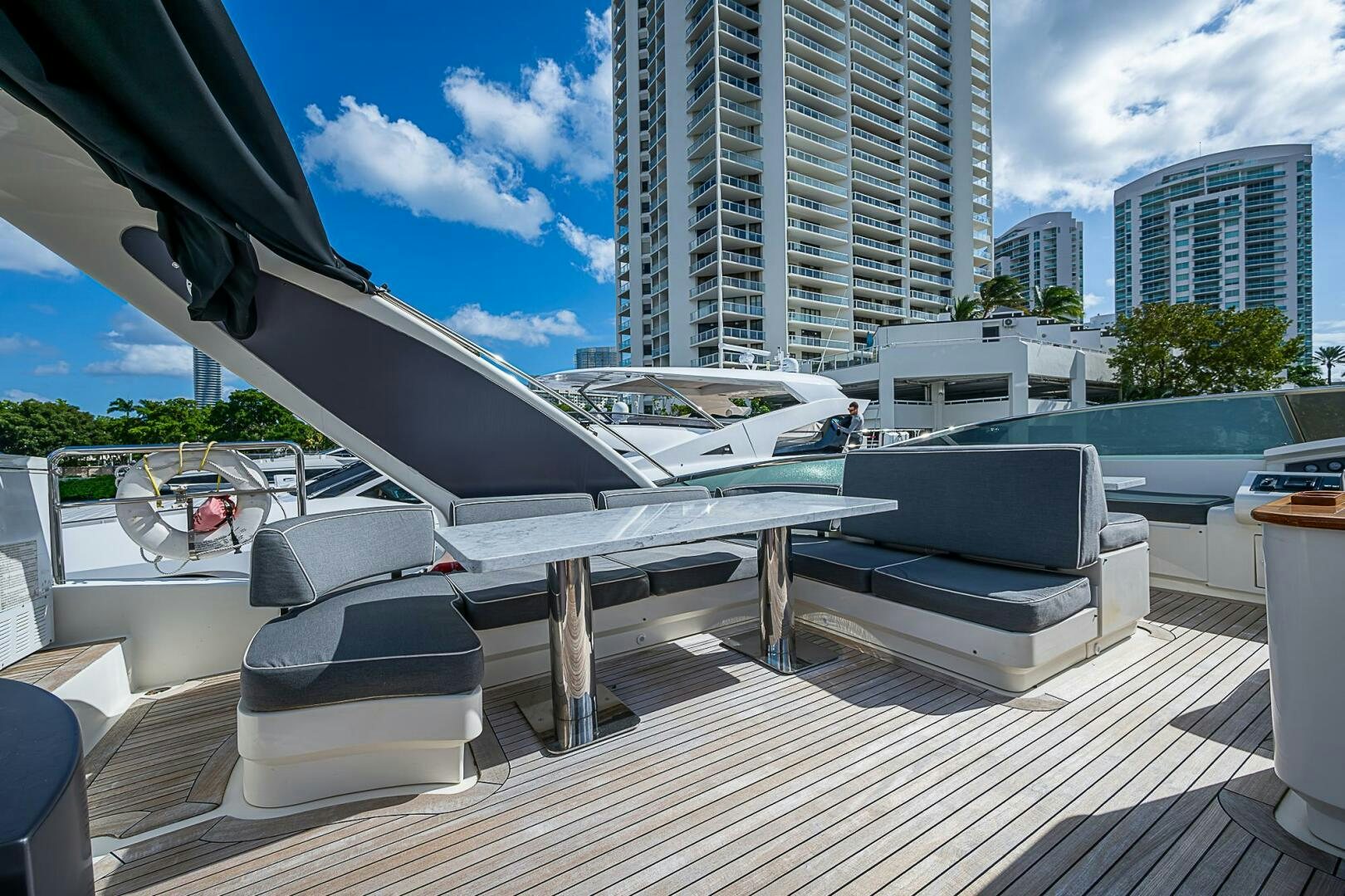 a deck with a large white boat and a large building in the background aboard INTERVENTION Yacht for Sale