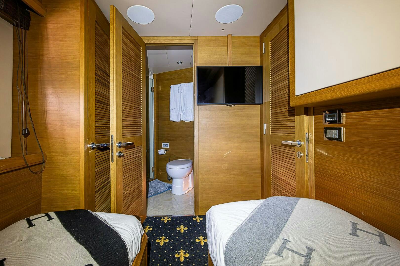 a room with a bed and a closet aboard INTERVENTION Yacht for Sale