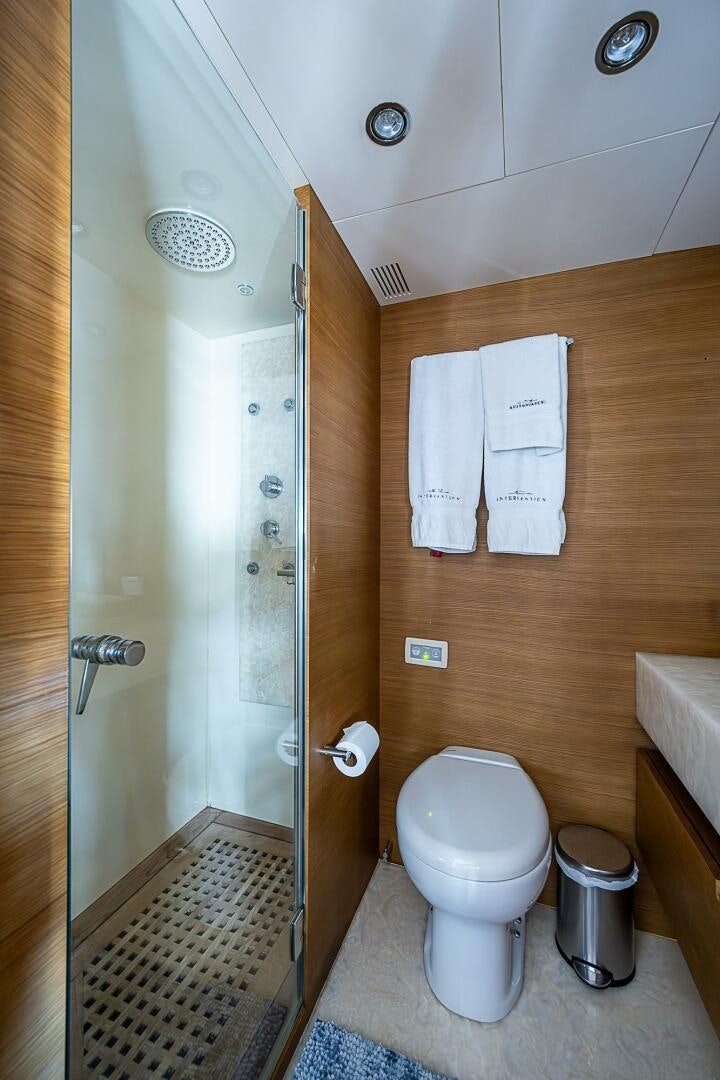 a bathroom with a toilet and a shower aboard INTERVENTION Yacht for Sale