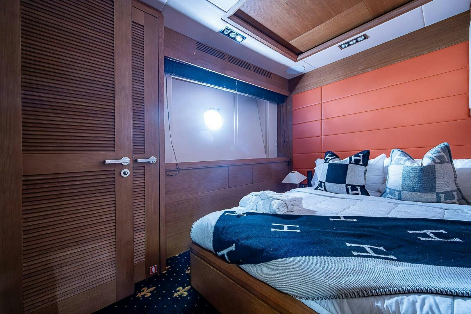 a room with a bed and a wood door aboard INTERVENTION Yacht for Sale