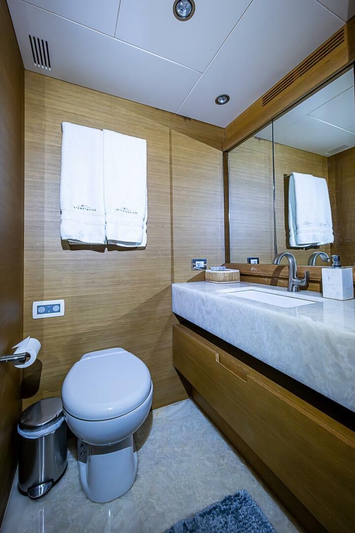 a bathroom with a toilet and sink aboard INTERVENTION Yacht for Sale