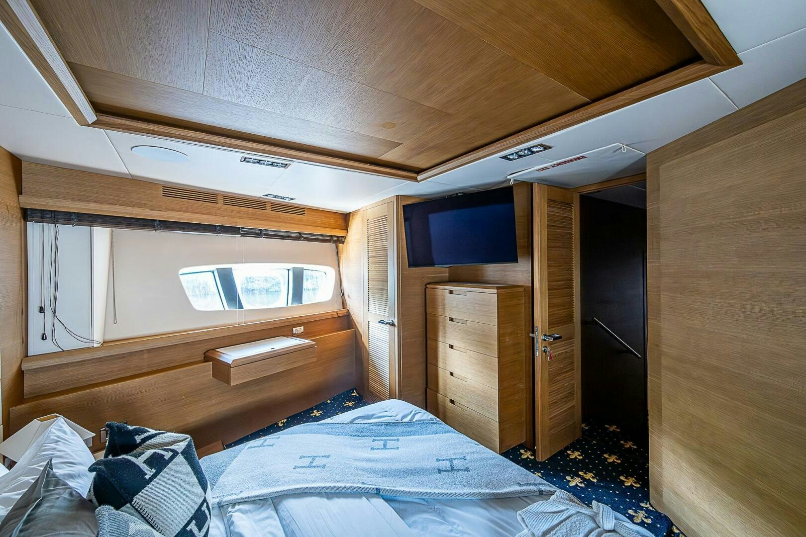 a cabin with a bed and a television aboard INTERVENTION Yacht for Sale