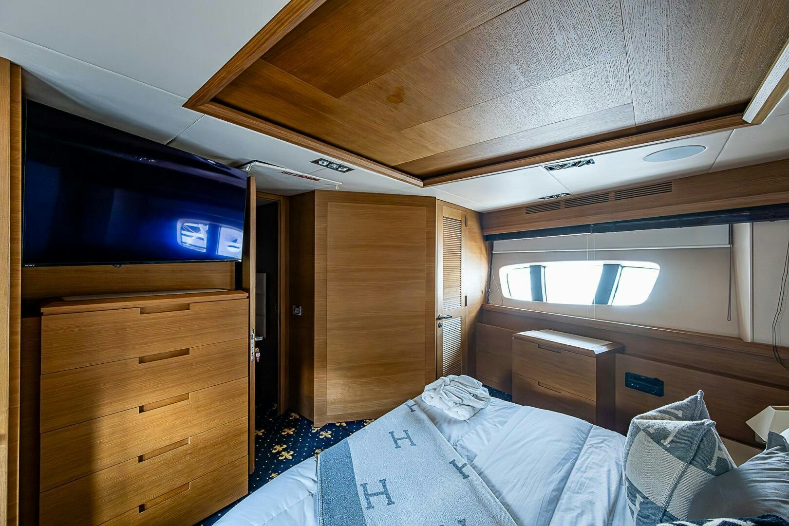 a bedroom with a bed and a tv aboard INTERVENTION Yacht for Sale