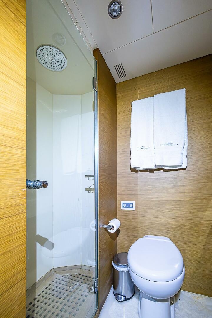 a bathroom with a toilet and a shower aboard INTERVENTION Yacht for Sale