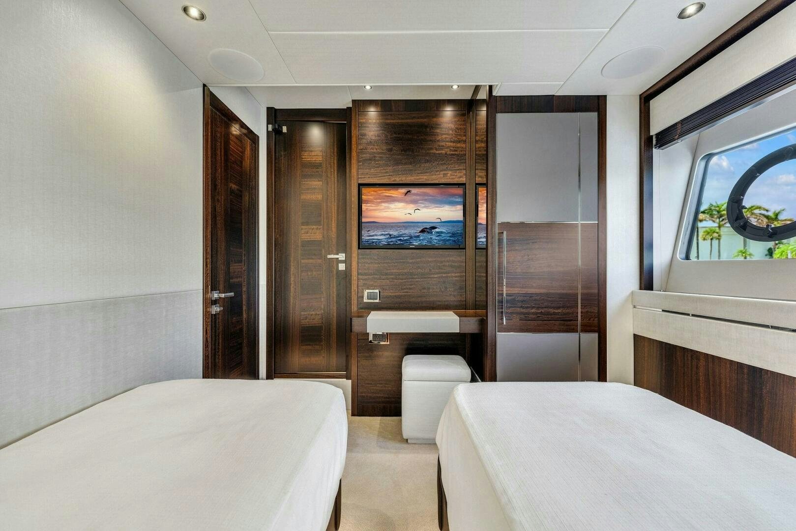 a room with a bed and a television aboard YOU AND ISLANDS Yacht for Sale