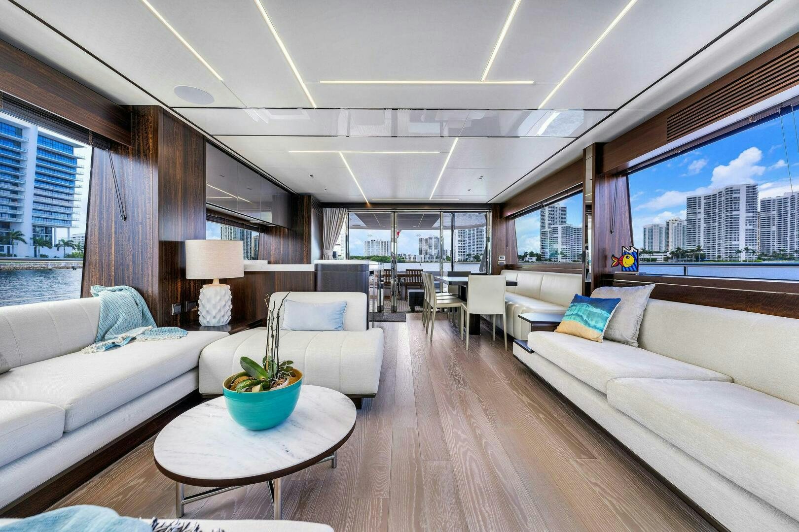 a living room with a large window aboard YOU AND ISLANDS Yacht for Sale