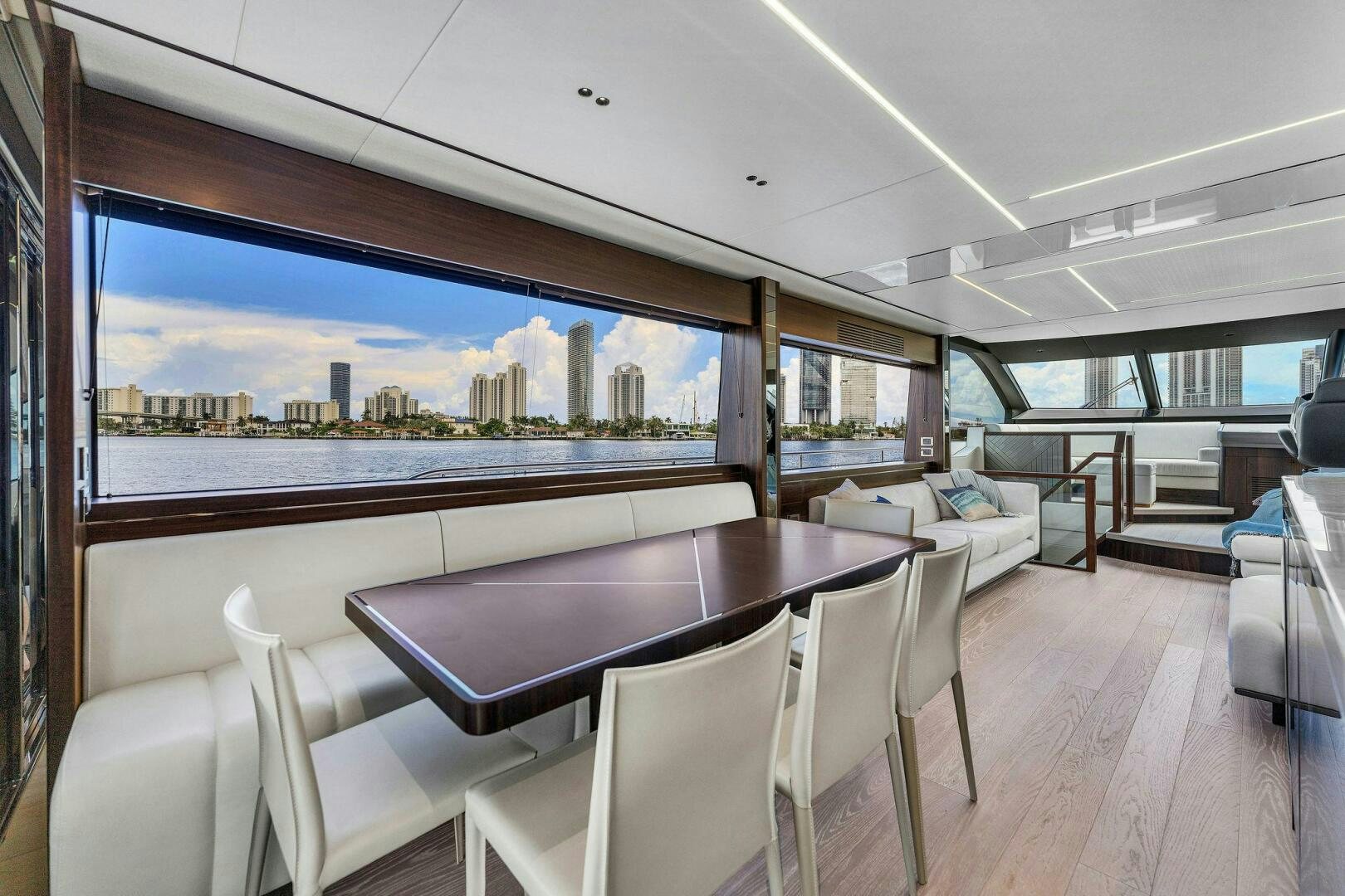 a large room with a table and chairs and a large window aboard YOU AND ISLANDS Yacht for Sale