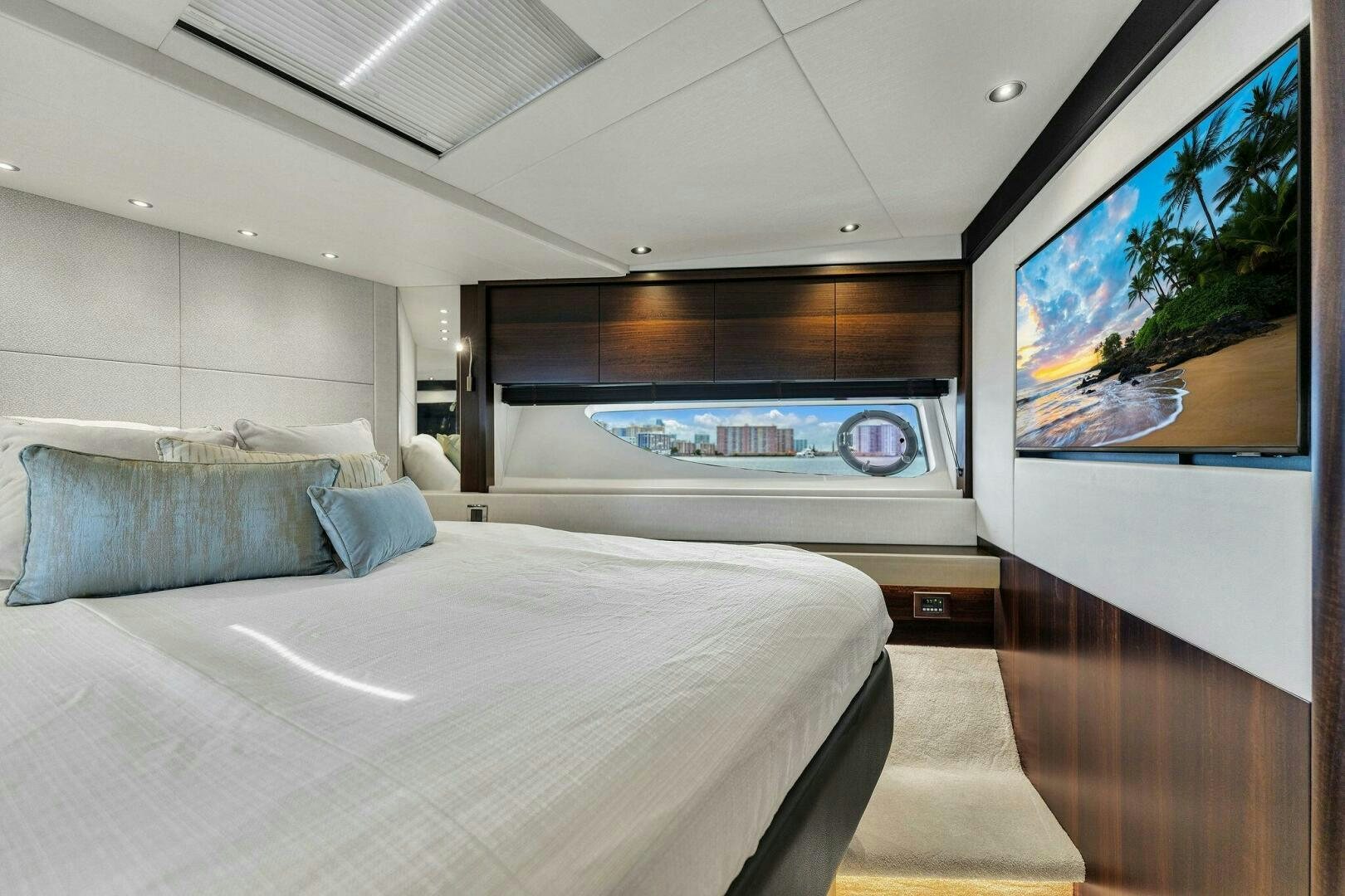 a room with a bed and a television aboard YOU AND ISLANDS Yacht for Sale