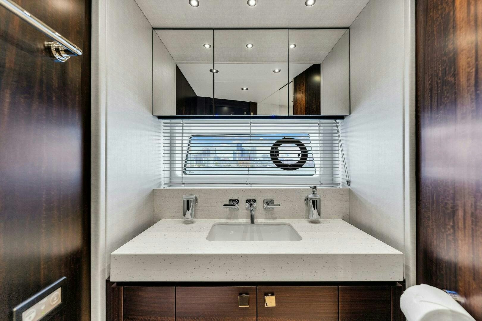 a bathroom with a sink and a mirror aboard YOU AND ISLANDS Yacht for Sale