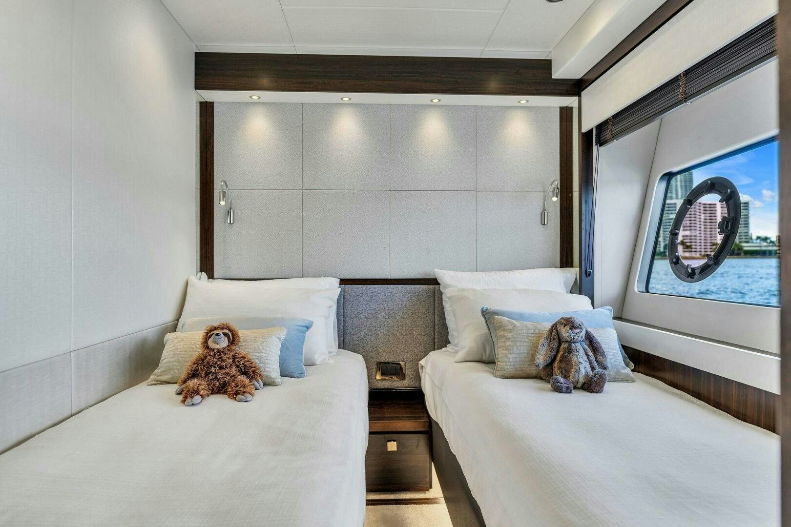 a bedroom with a bed and a plush toy aboard YOU AND ISLANDS Yacht for Sale