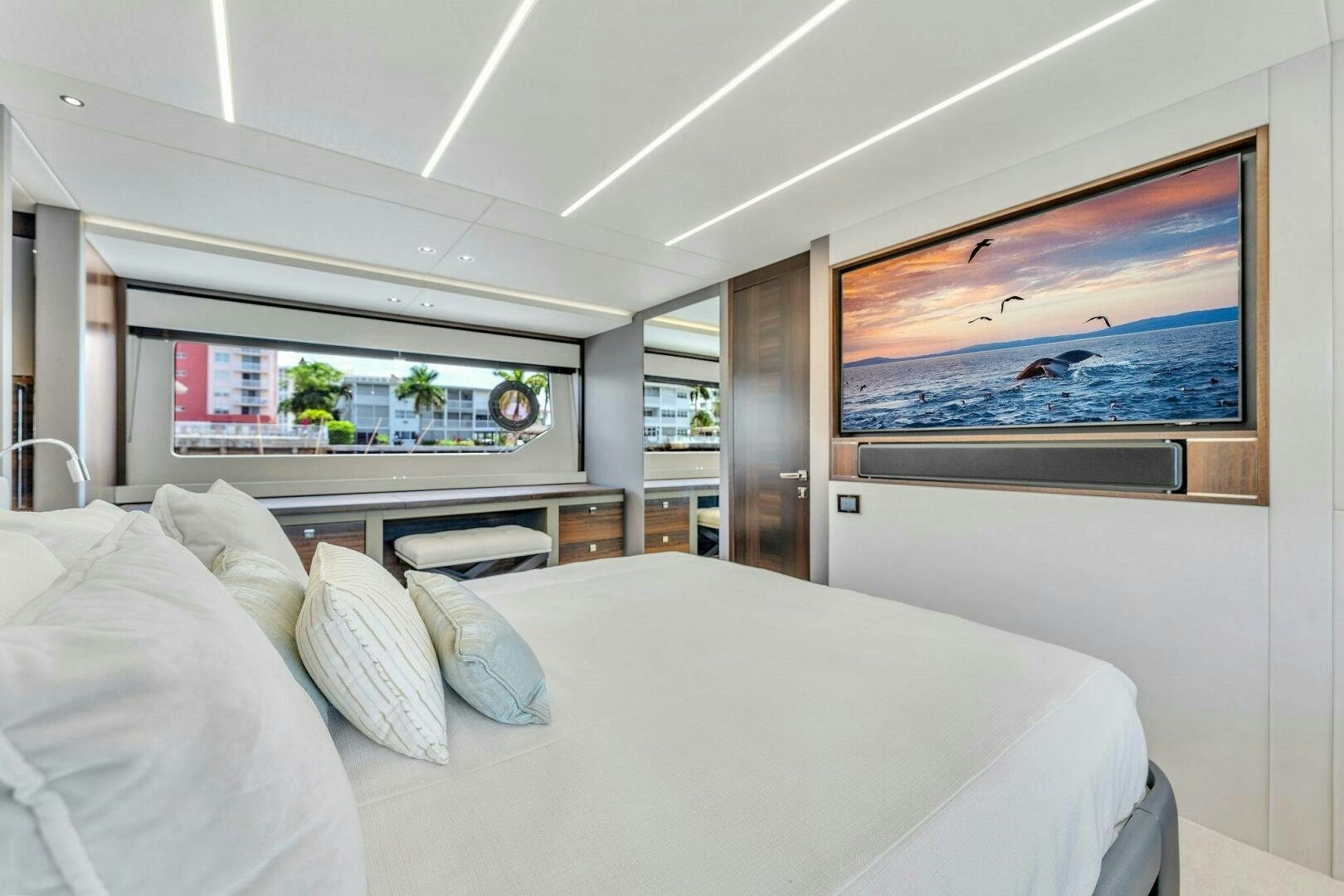 a room with a bed and a television on the wall aboard YOU AND ISLANDS Yacht for Sale