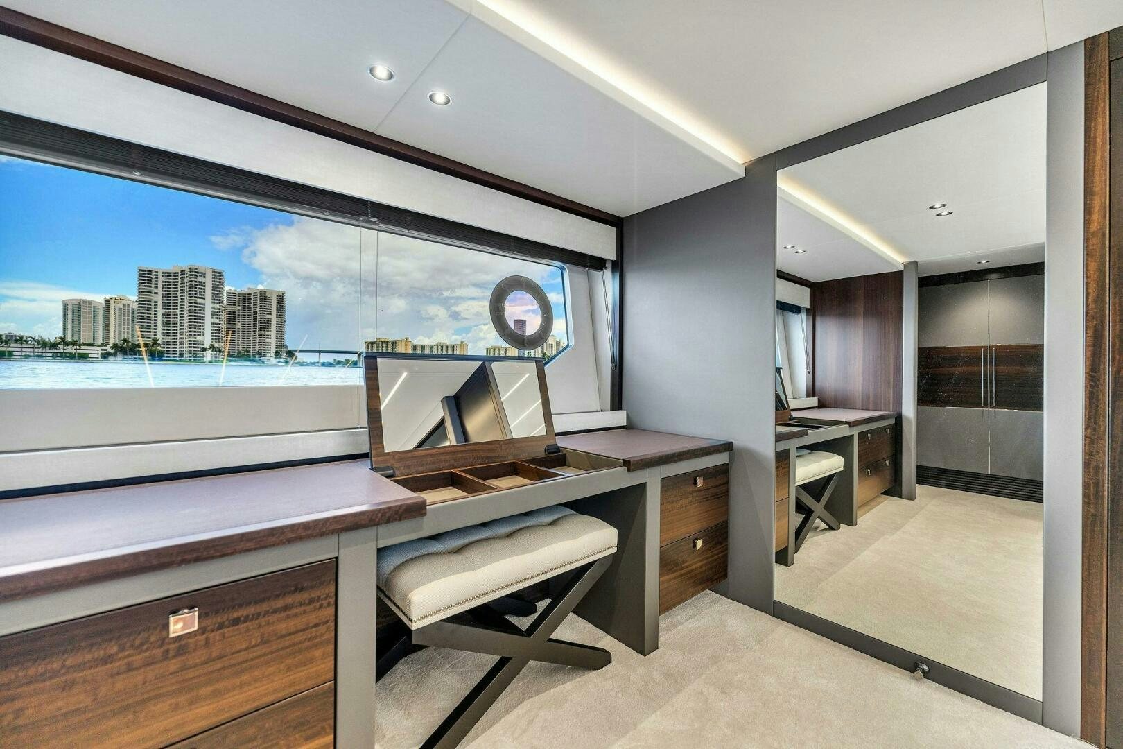a room with a large window and a desk with a view of a city aboard YOU AND ISLANDS Yacht for Sale