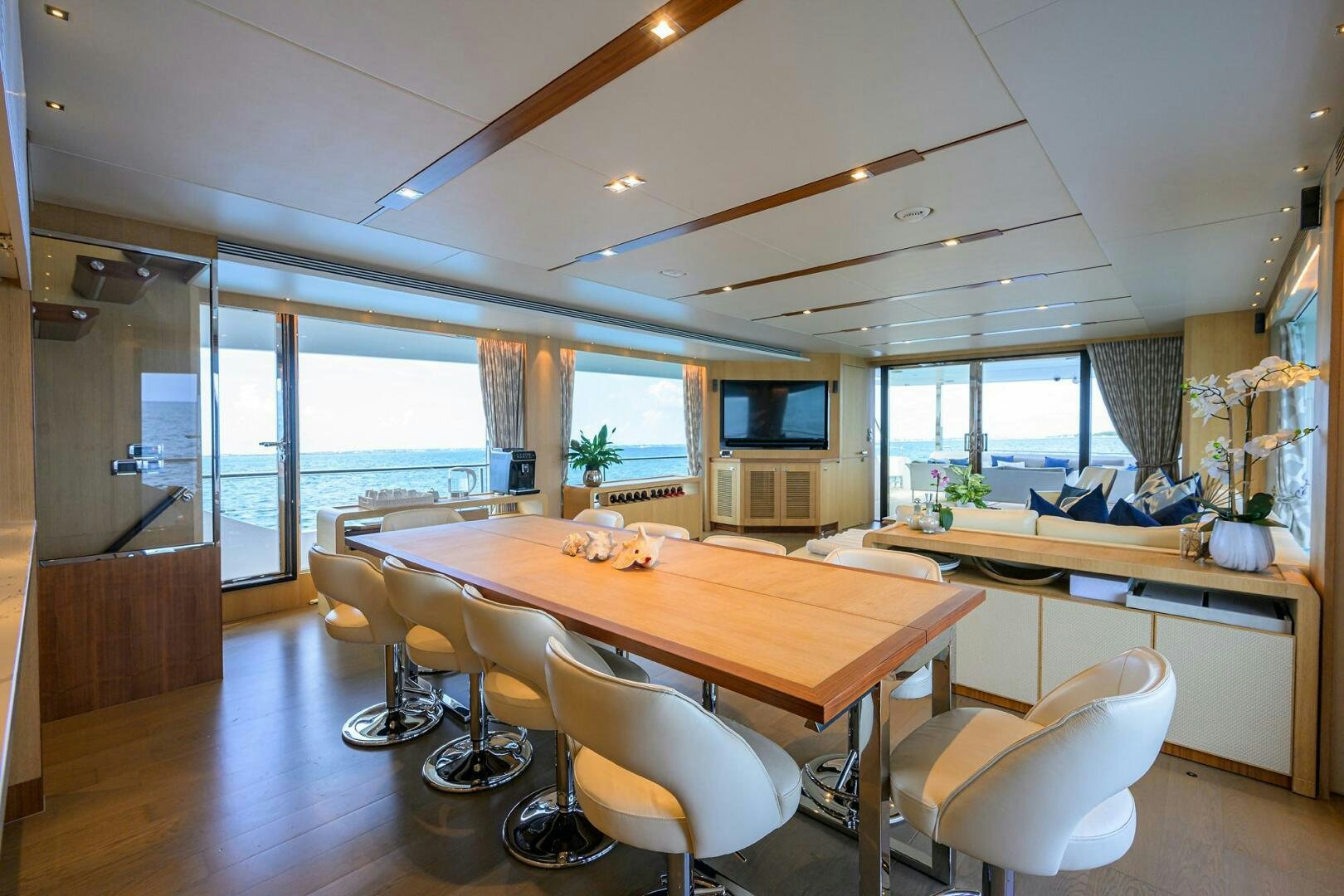 a large room with a table and chairs aboard AQUA LIFE Yacht for Sale