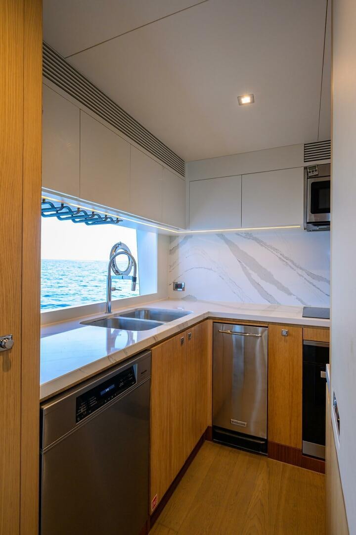 a kitchen with a sink and a window aboard AQUA LIFE Yacht for Sale