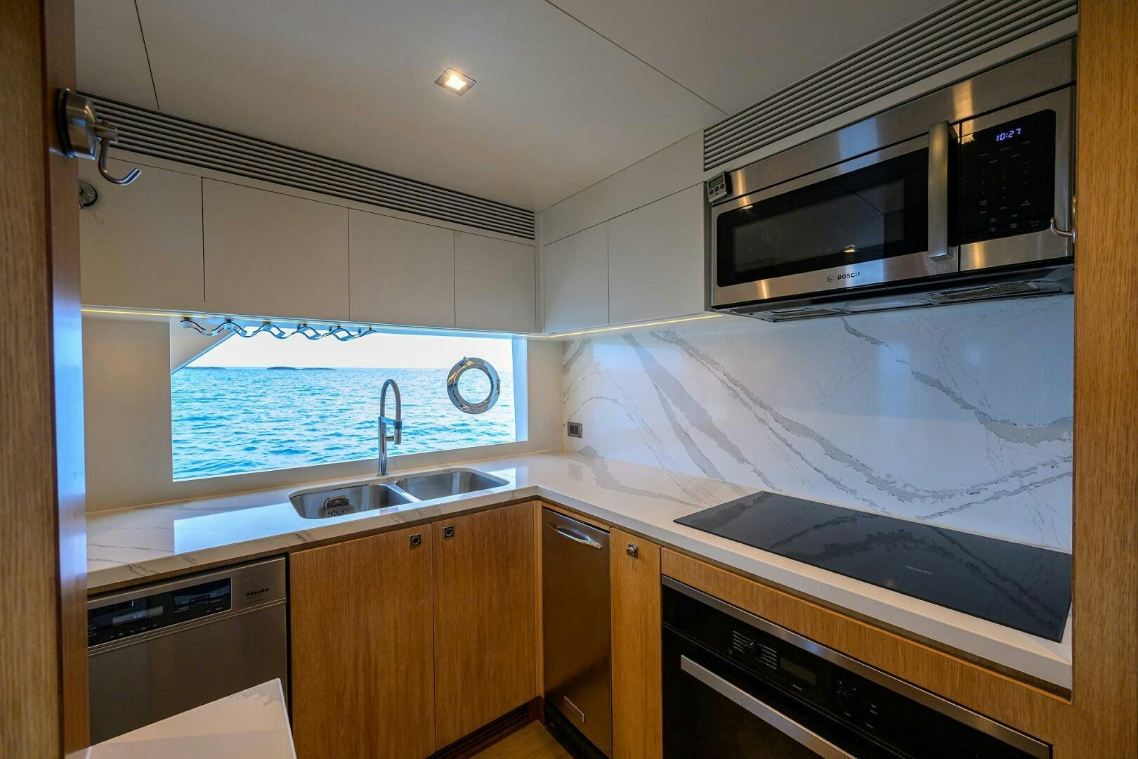 a kitchen with a large window aboard AQUA LIFE Yacht for Sale