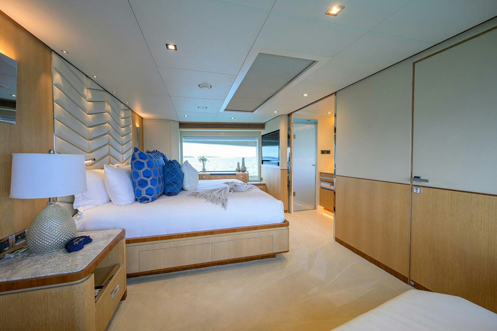 a bedroom with a bed and a desk aboard AQUA LIFE Yacht for Sale