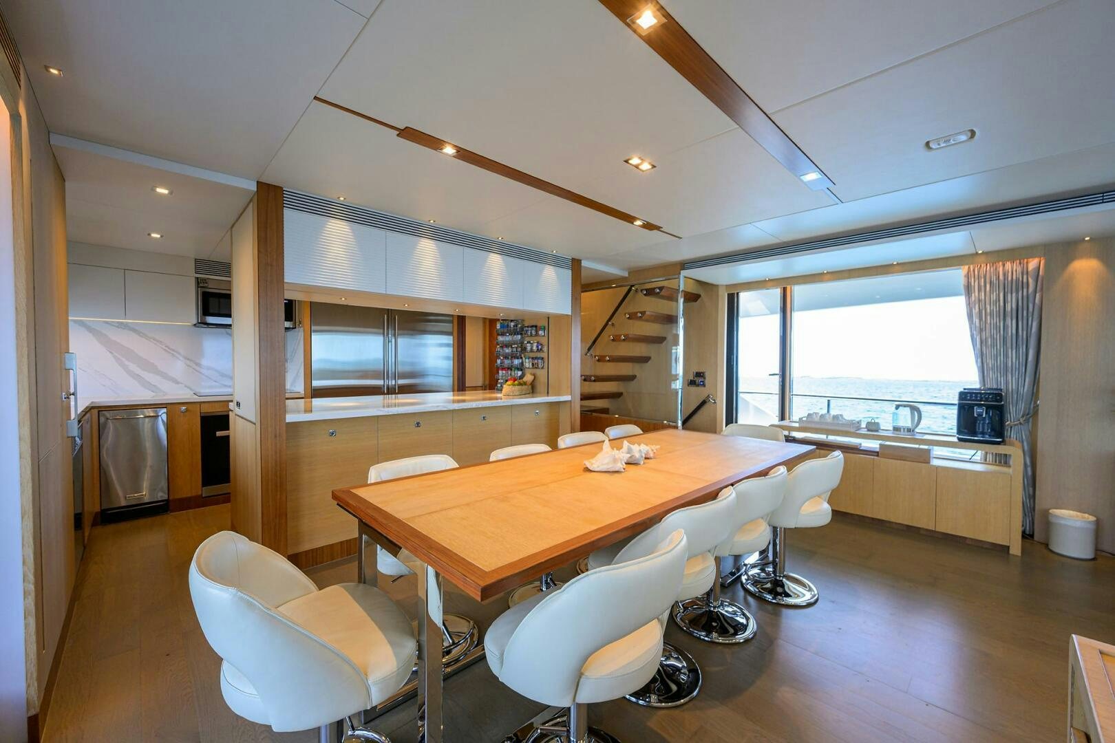 a large room with a table and chairs aboard AQUA LIFE Yacht for Sale