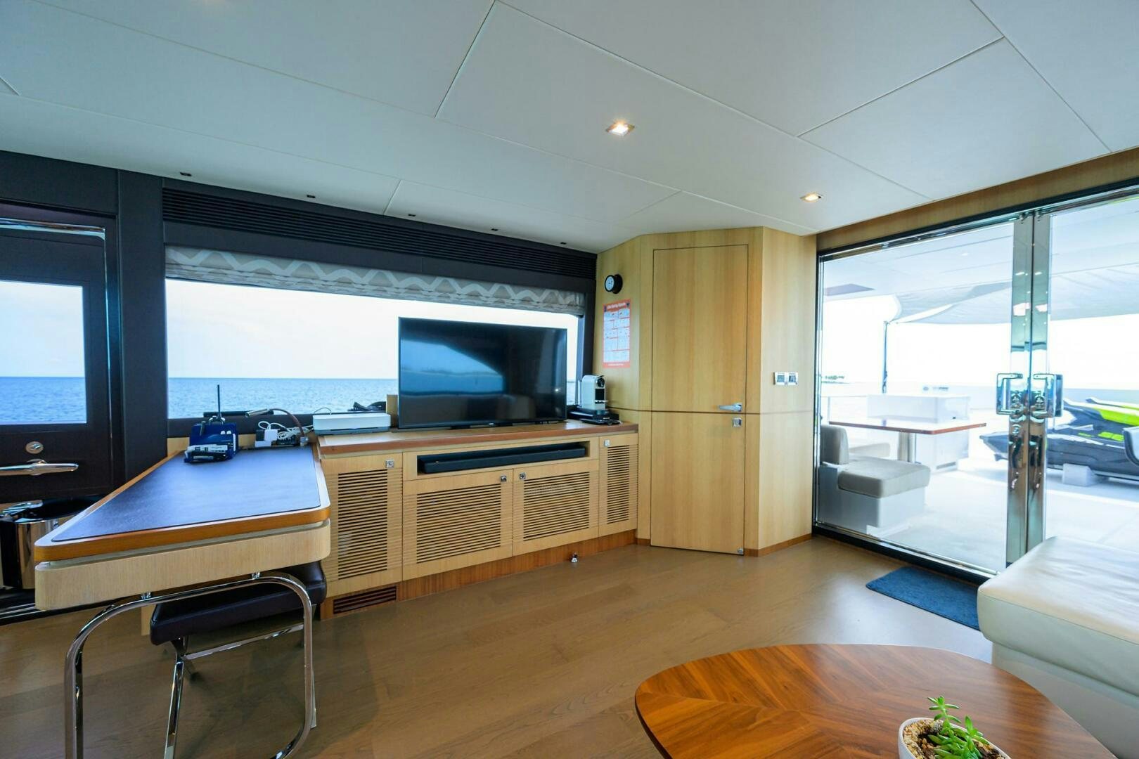 a room with a desk and a tv aboard AQUA LIFE Yacht for Sale