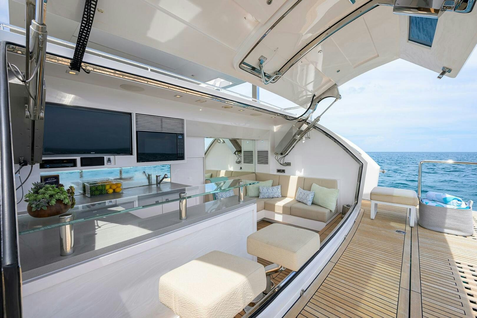 a modern looking living room with a large open kitchen and a large window aboard AQUA LIFE Yacht for Sale