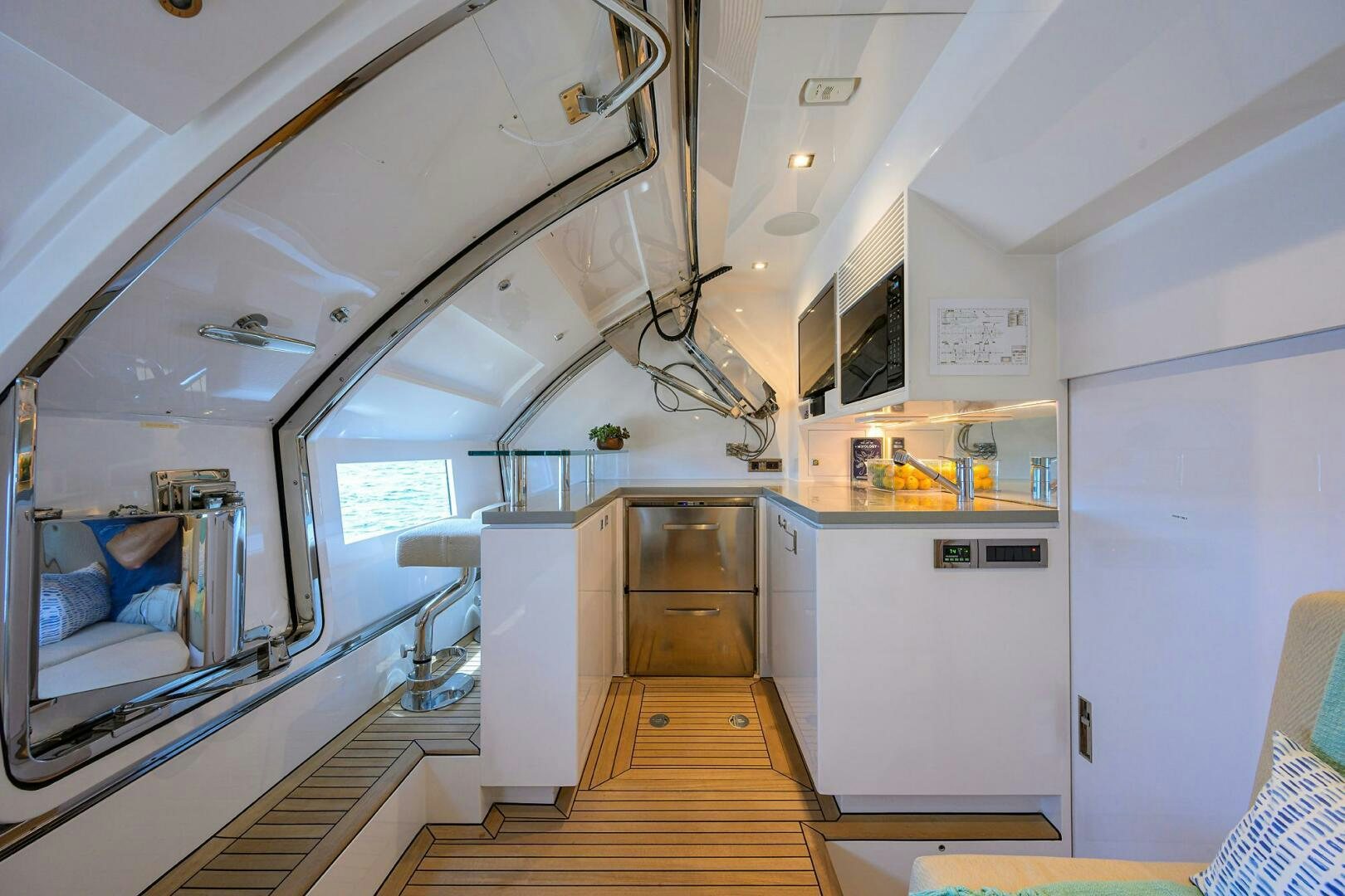 a room with a wood floor and a large window aboard AQUA LIFE Yacht for Sale