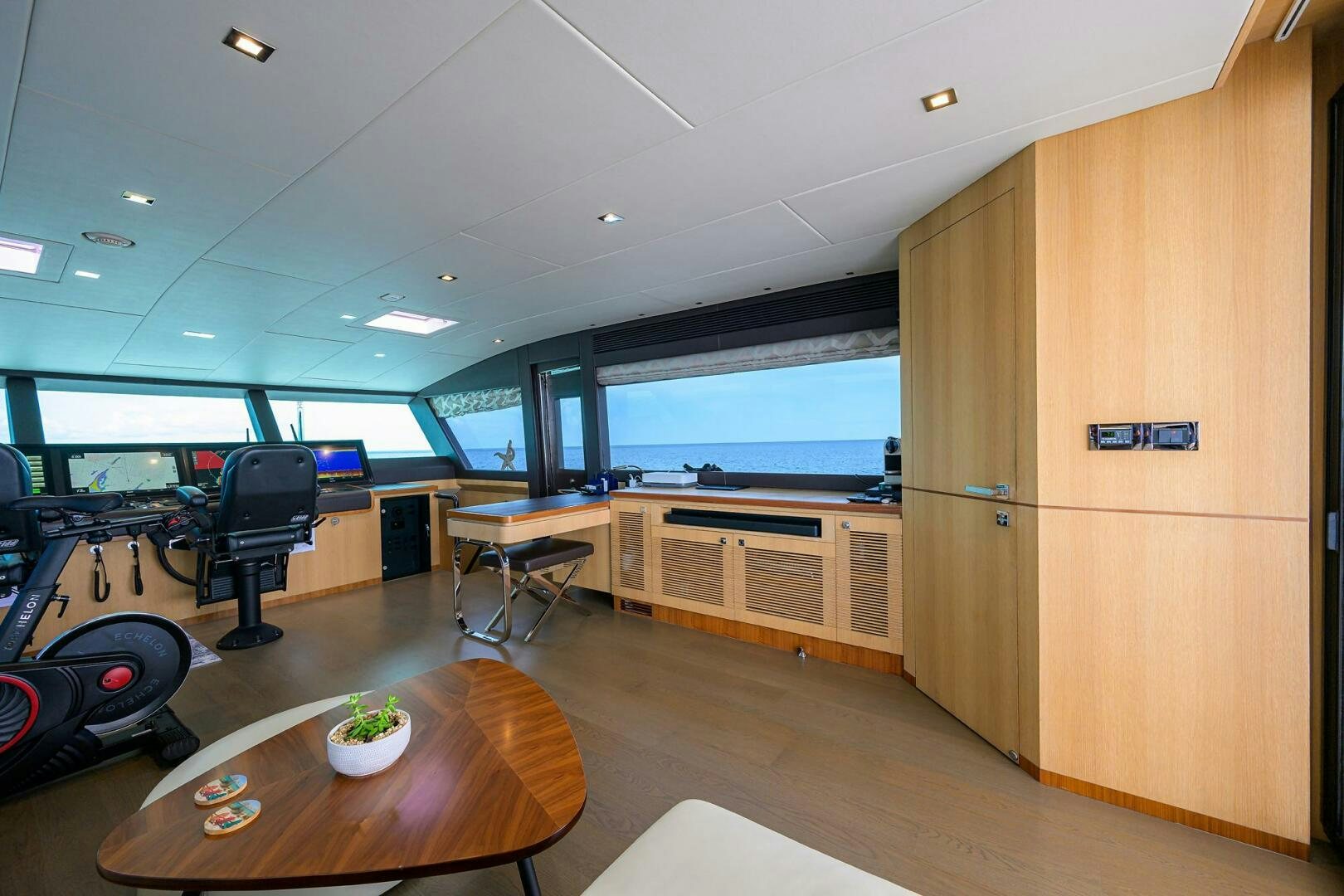 a room with a table and chairs aboard AQUA LIFE Yacht for Sale