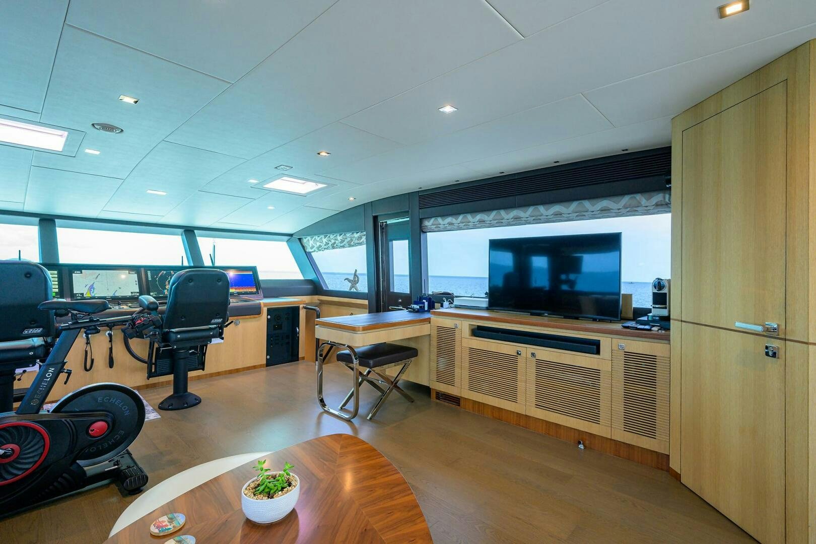 a room with a table and chairs aboard AQUA LIFE Yacht for Sale