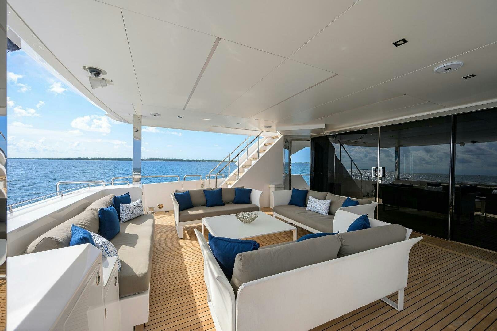 a room with a large balcony overlooking the ocean aboard AQUA LIFE Yacht for Sale