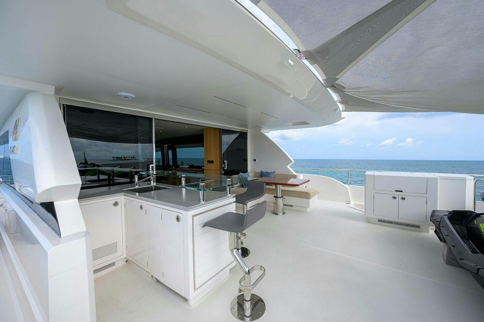 a room with a large white table and chairs and a large window aboard AQUA LIFE Yacht for Sale