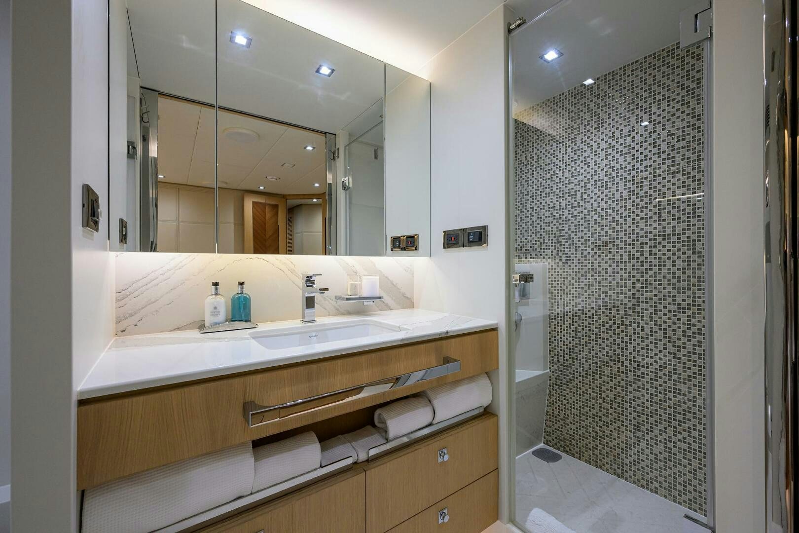 a bathroom with a glass shower aboard AQUA LIFE Yacht for Sale