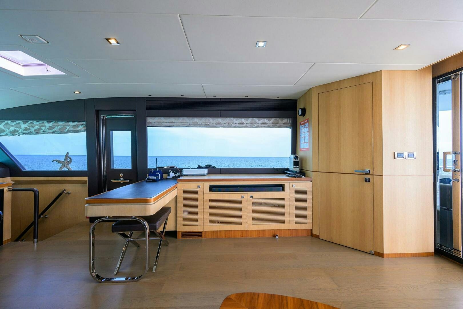 a room with a table and chairs aboard AQUA LIFE Yacht for Sale