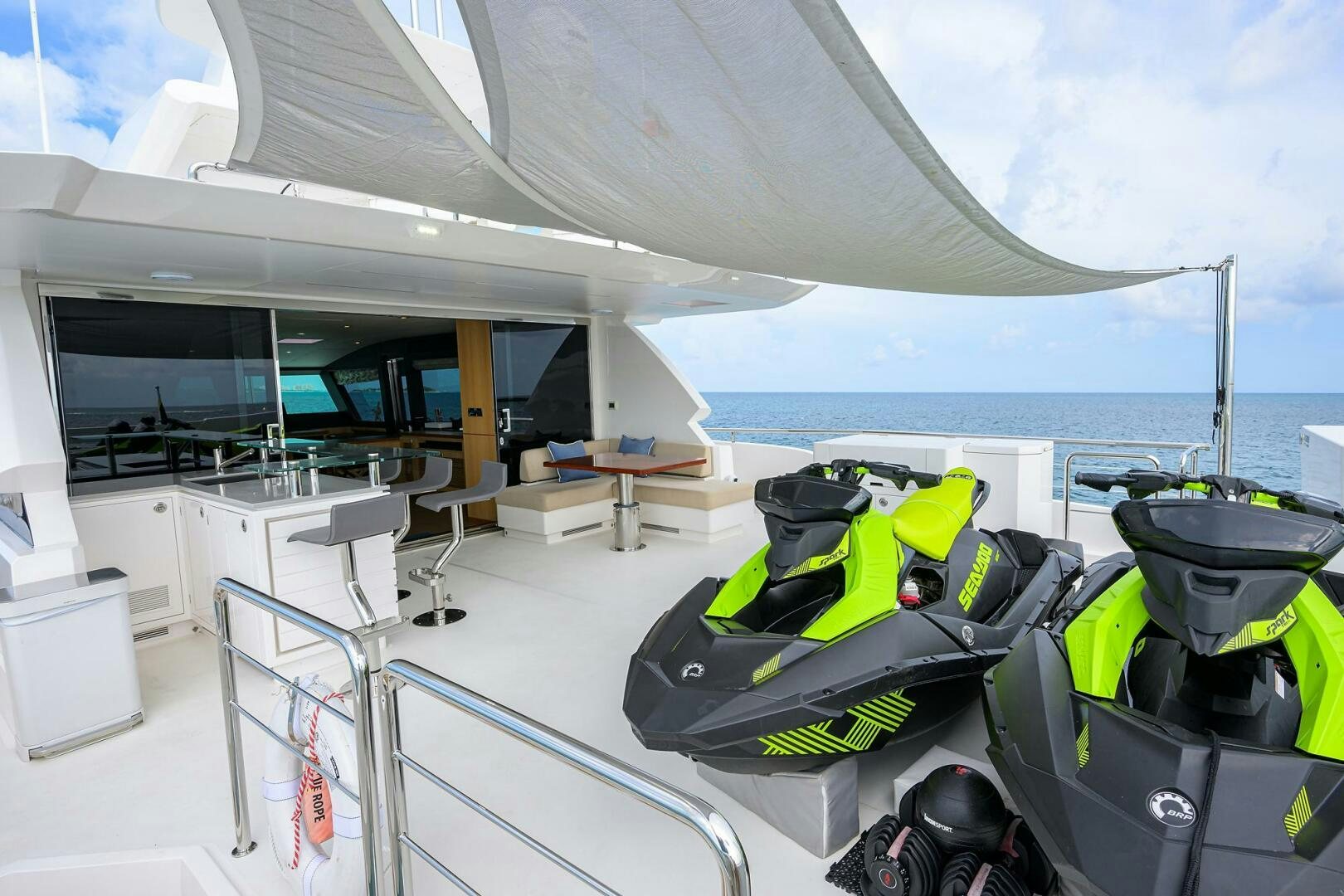 a boat with a green lawn chair and a table and chairs on a boat aboard AQUA LIFE Yacht for Sale