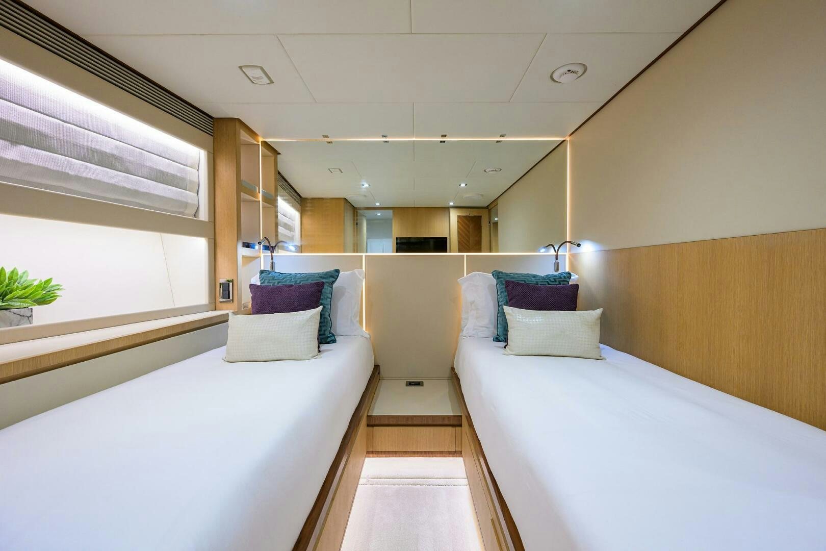 a room with beds and a window aboard AQUA LIFE Yacht for Sale