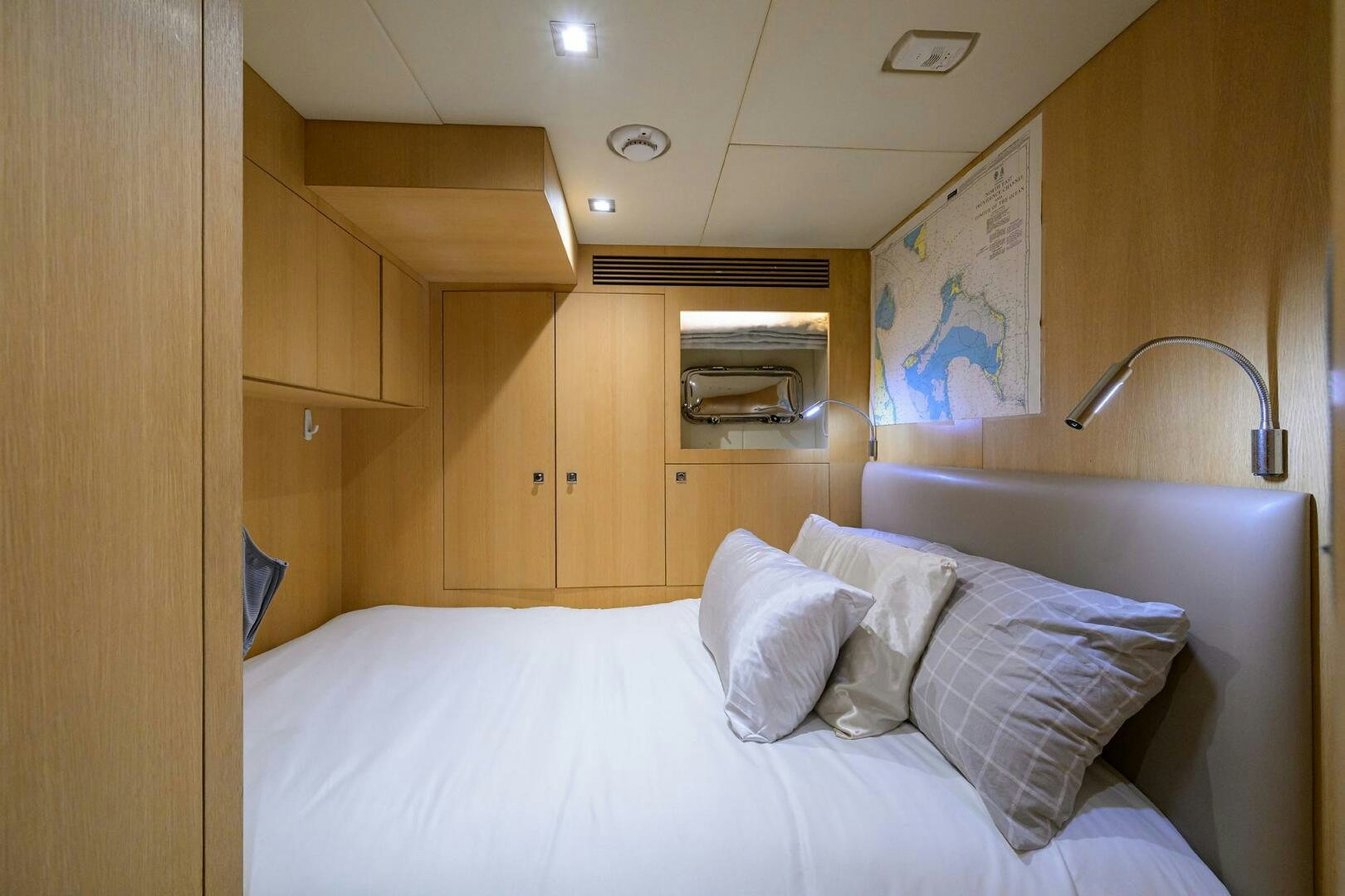 a bed with white sheets aboard AQUA LIFE Yacht for Sale