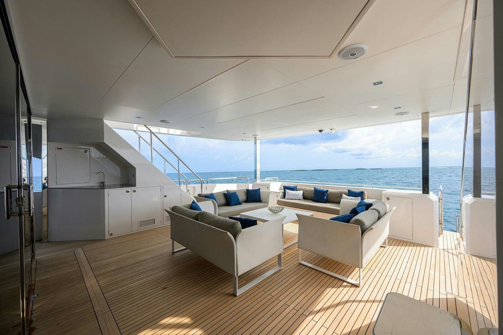 a room with a view of the ocean and a balcony aboard AQUA LIFE Yacht for Sale