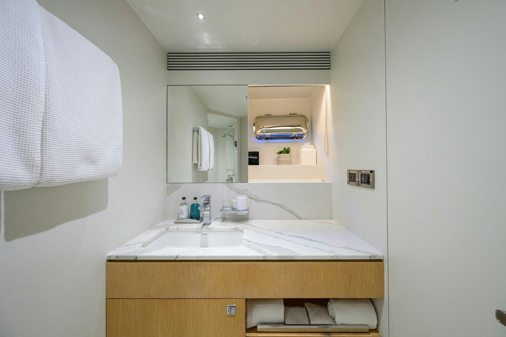 a bathroom with a sink and a mirror aboard AQUA LIFE Yacht for Sale