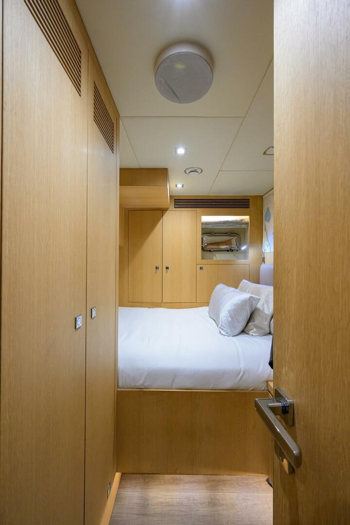 a room with a bed and a mirror aboard AQUA LIFE Yacht for Sale