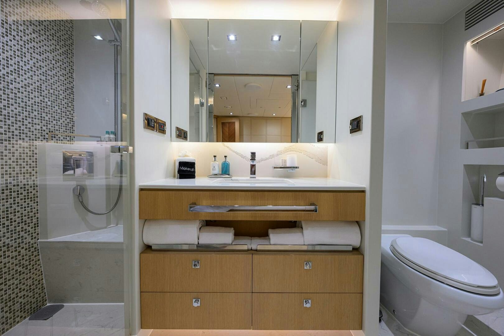 a bathroom with a mirror and a toilet aboard AQUA LIFE Yacht for Sale
