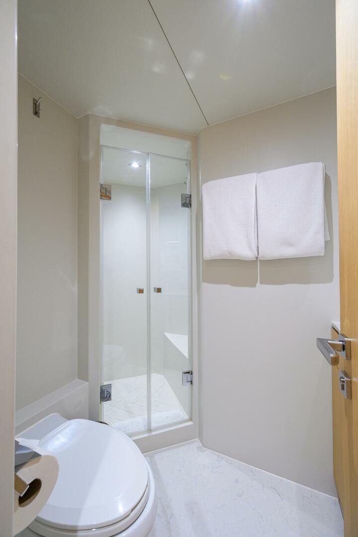 a bathroom with a shower and toilet aboard AQUA LIFE Yacht for Sale