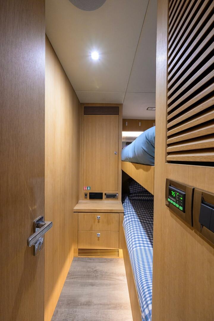 a room with a bed and a desk aboard AQUA LIFE Yacht for Sale