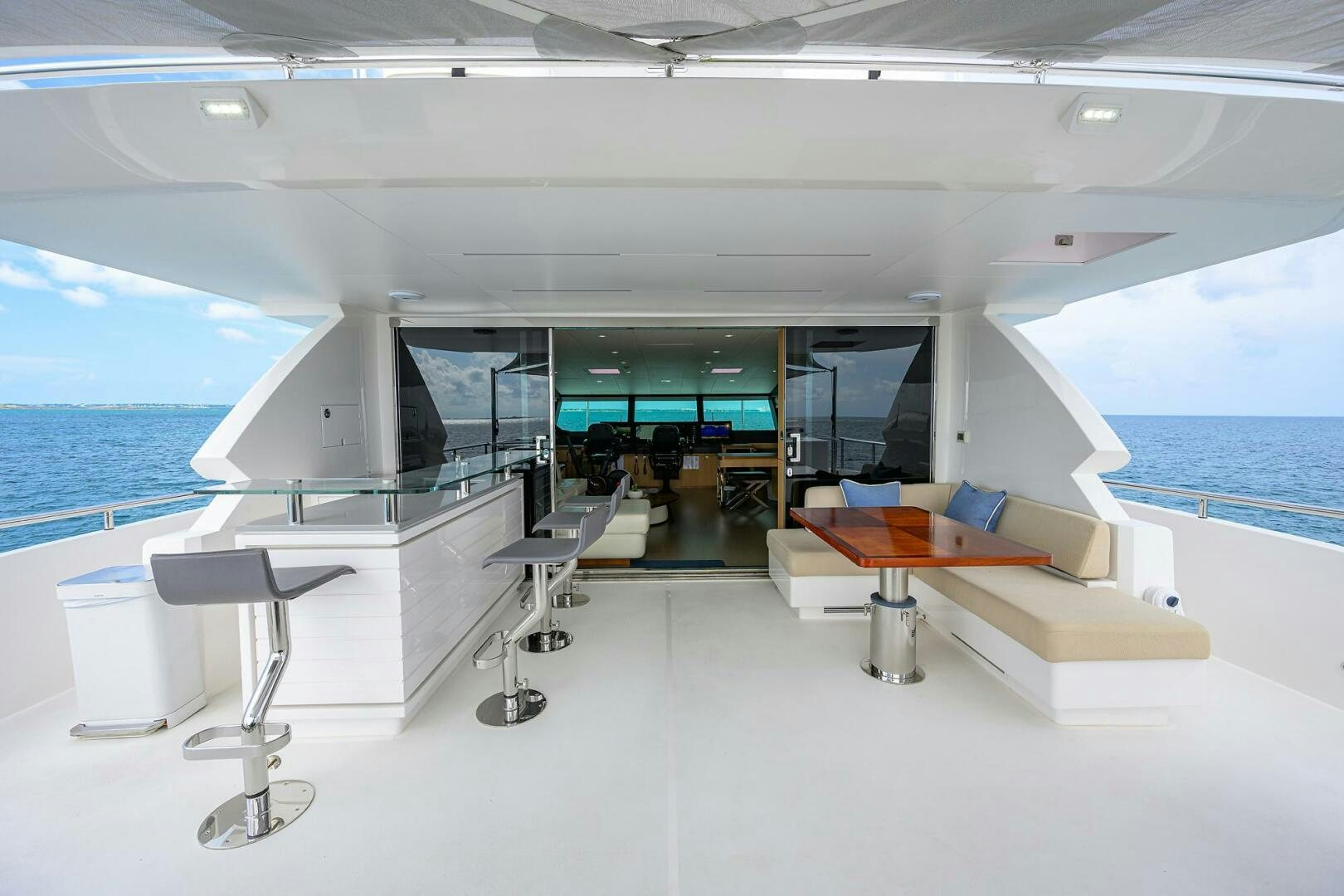 a room with a table and chairs aboard AQUA LIFE Yacht for Sale