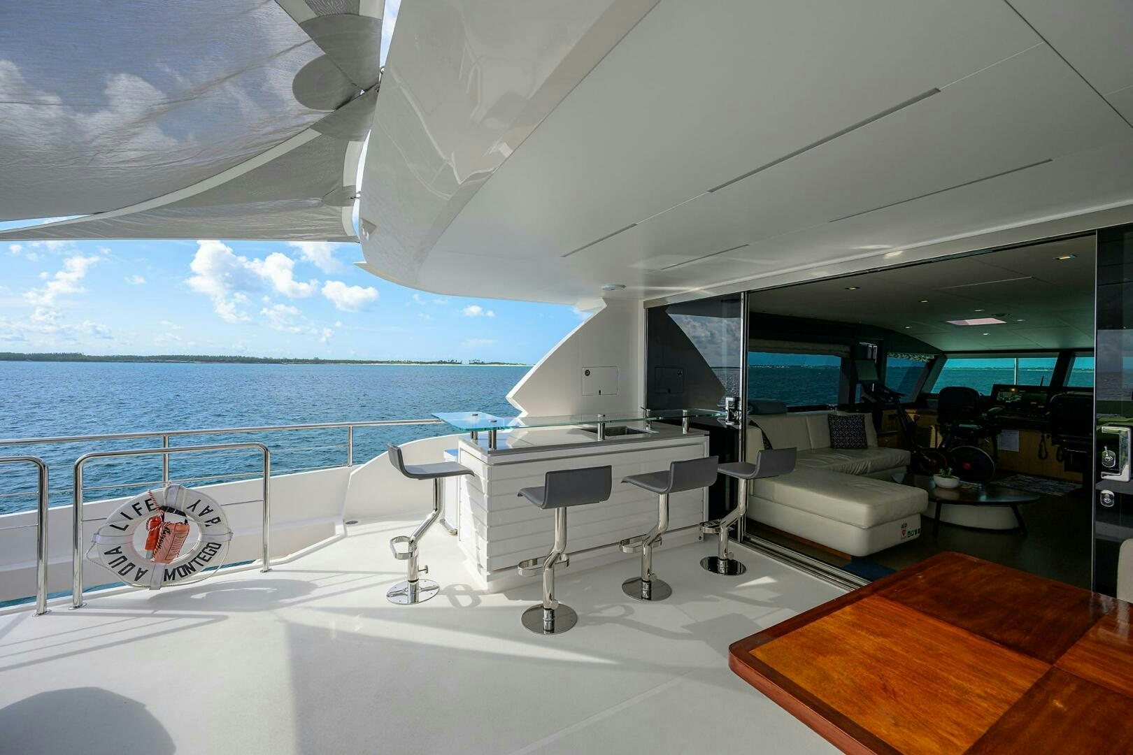 a room with a table and chairs aboard AQUA LIFE Yacht for Sale
