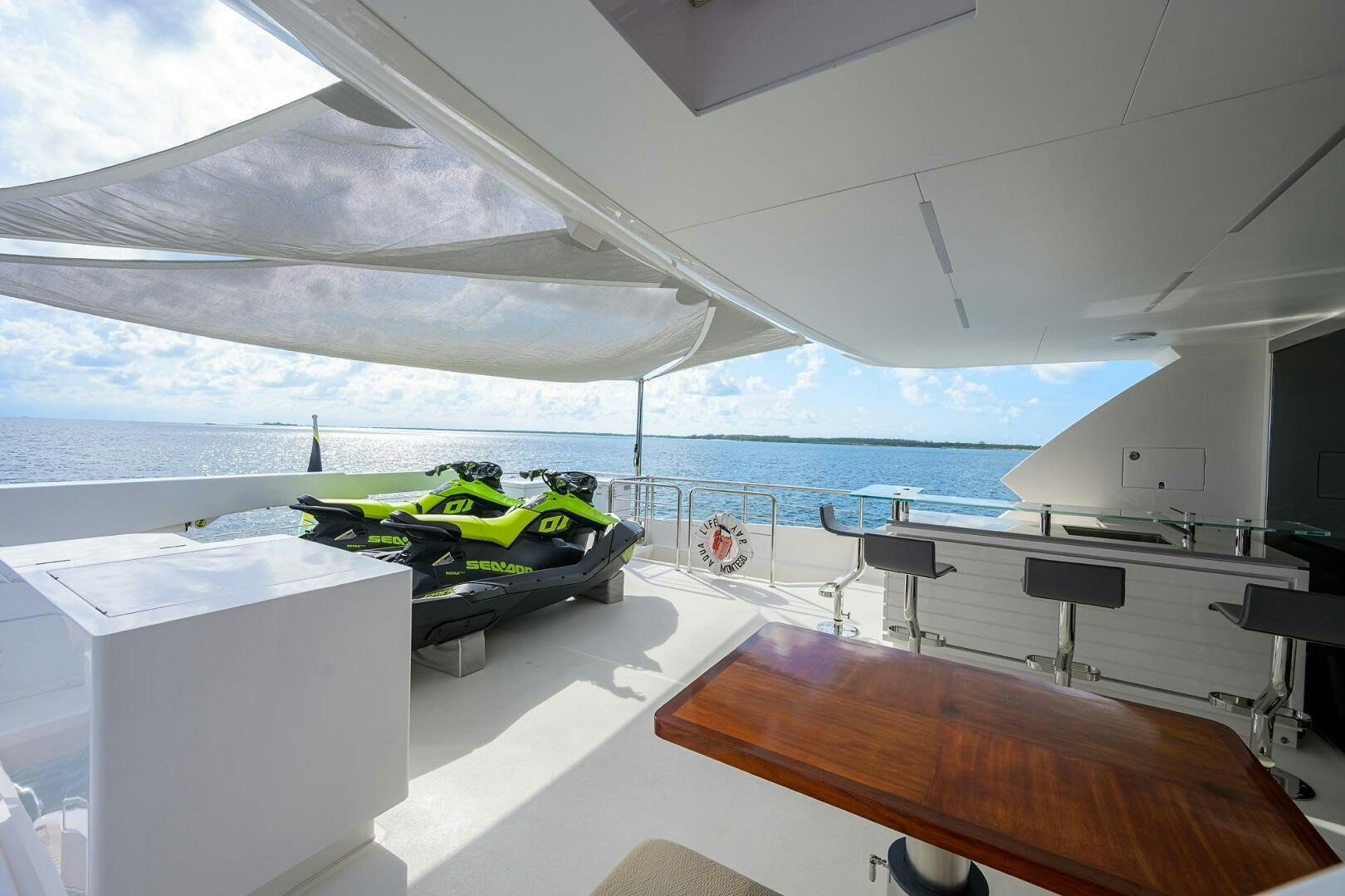 a room with a table and chairs aboard AQUA LIFE Yacht for Sale