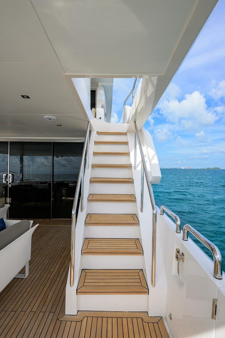 a wooden staircase leading to a large glass door on a boat aboard AQUA LIFE Yacht for Sale