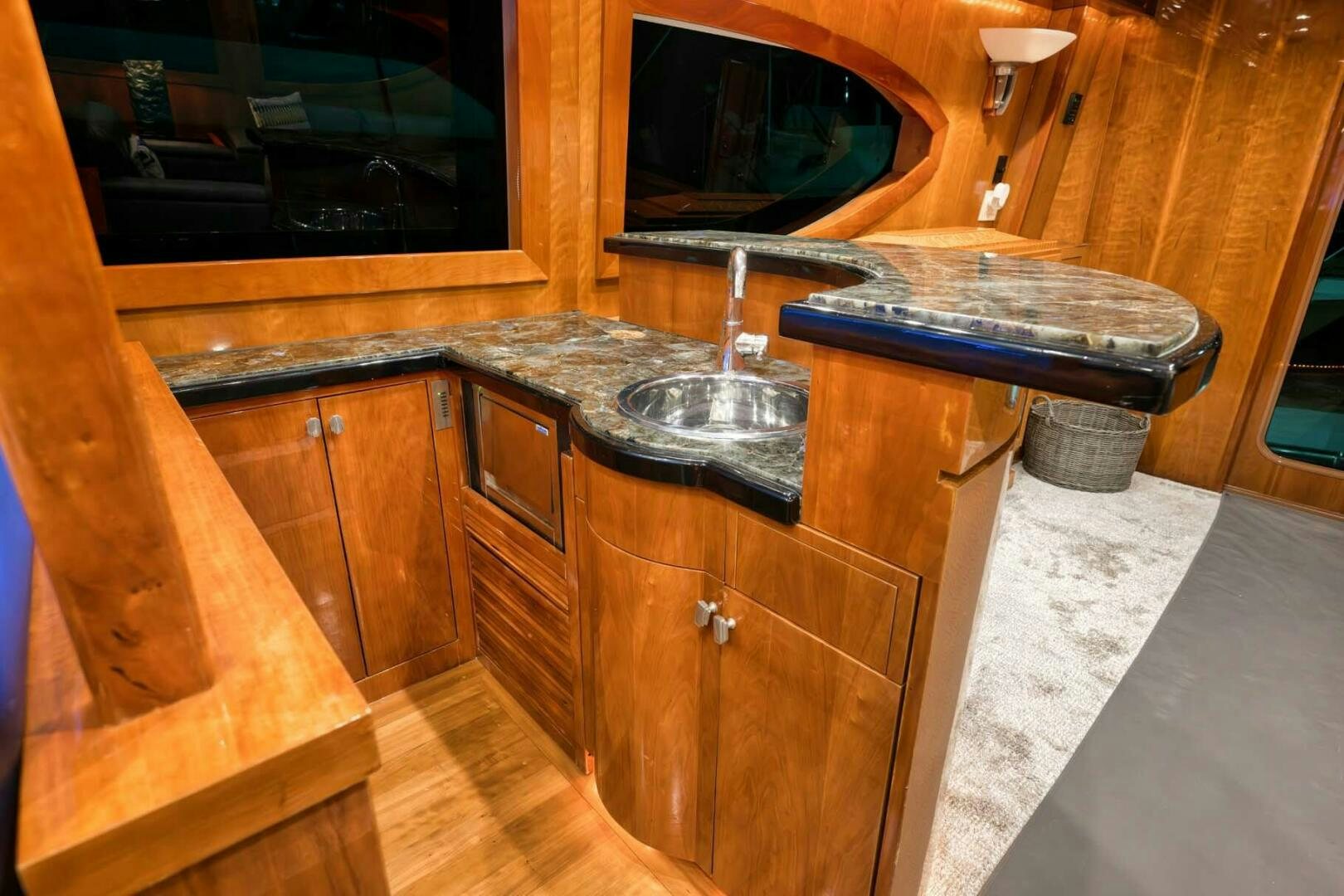 a kitchen with wooden cabinets aboard REEL TRADER Yacht for Sale