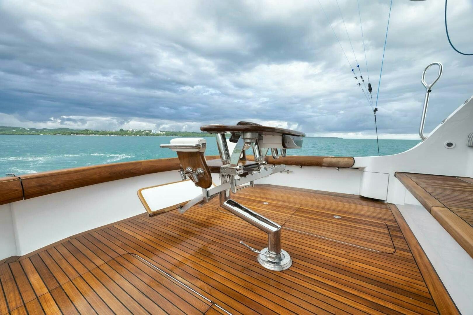 a deck with a view of the ocean and the ocean aboard REEL TRADER Yacht for Sale