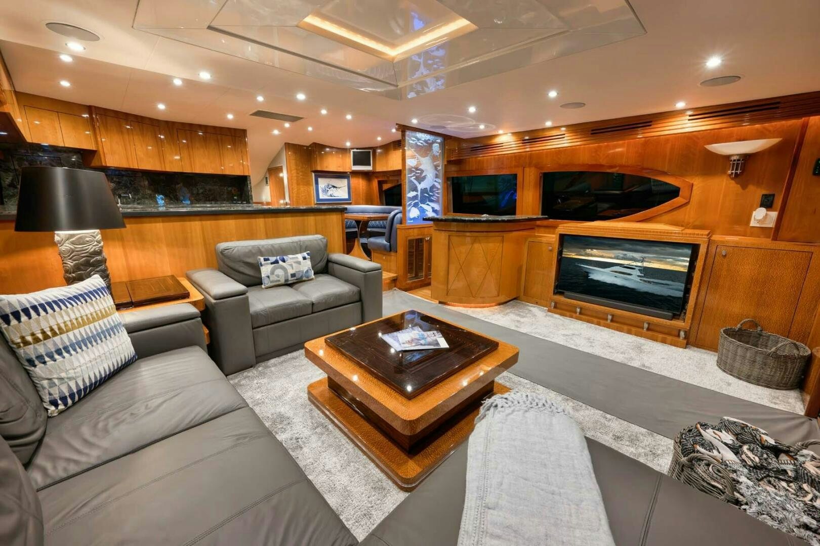 a living room with a fireplace aboard REEL TRADER Yacht for Sale