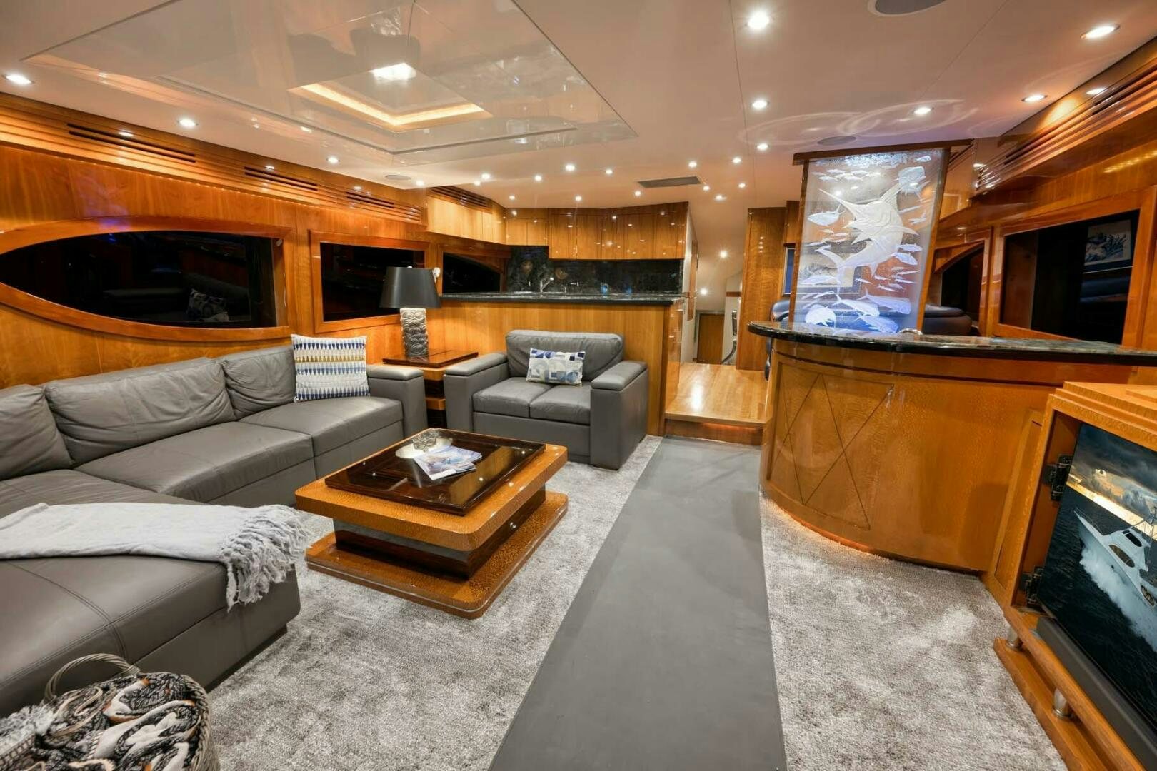 a living room with a fireplace aboard REEL TRADER Yacht for Sale