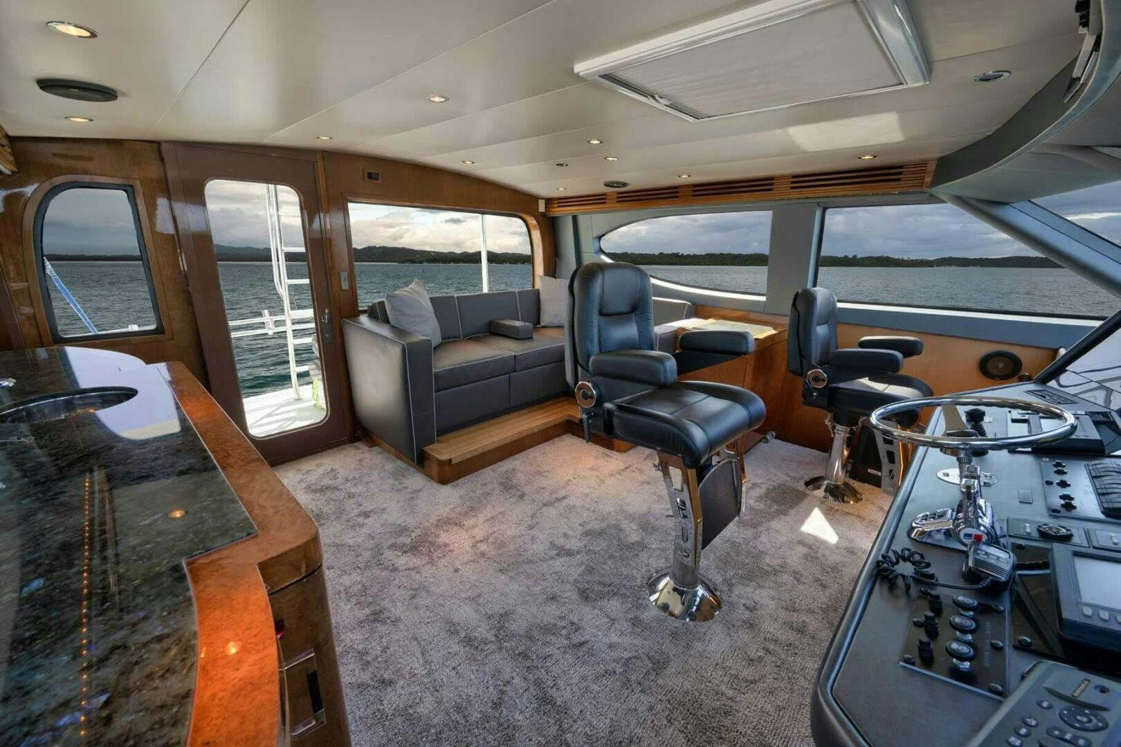 a room with a couch and a table and chairs aboard REEL TRADER Yacht for Sale