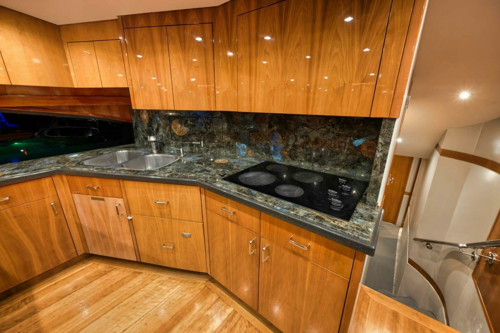 a kitchen with wooden cabinets aboard REEL TRADER Yacht for Sale