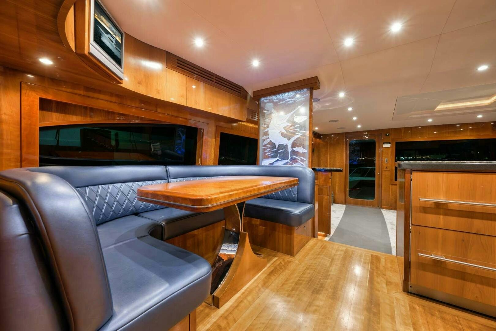 a living room with a couch and a table aboard REEL TRADER Yacht for Sale